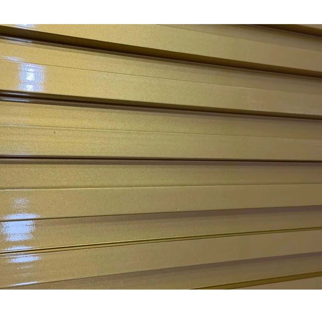 Close-up of golden metallic profiles, likely for trim or decorative wall accents. by PVC Global Imports USA LLC in Roselle, N