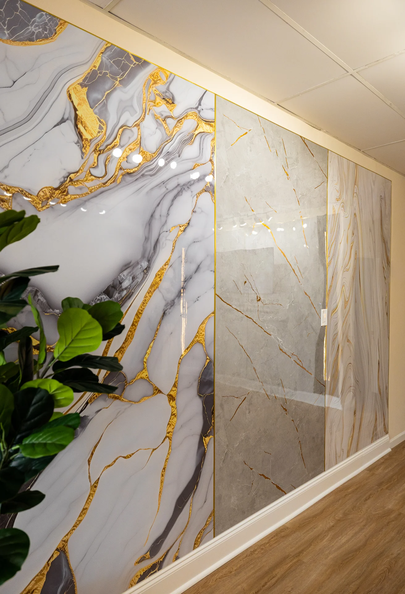 Elegant wall panels with white, gray, and gold marble patterns in a modern room. by PVC Global Imports USA LLC in Clark, NJ